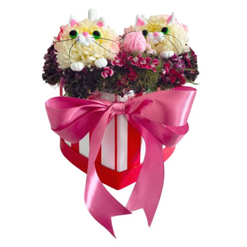 Arreglo floral artesanal de dos gatitos blancos en caja de corazón a rayas con moño rosado grande de Jinga Pop Guatemala